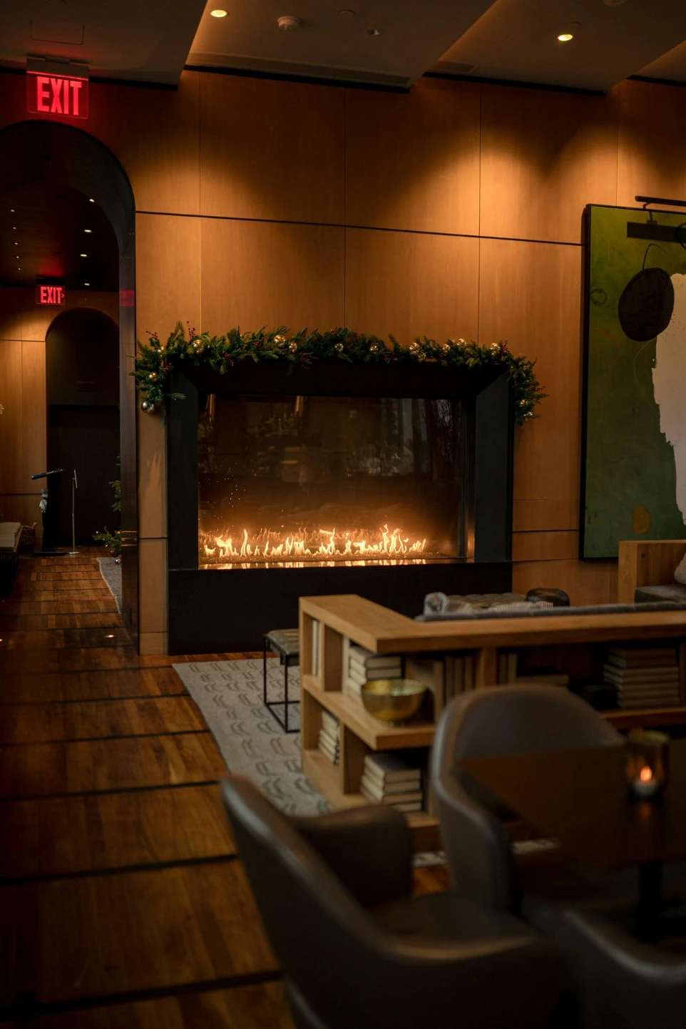 a fire place in a restaurant with chairs and tables